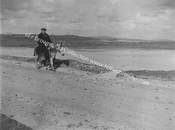 FARMER RIDING DONKEY